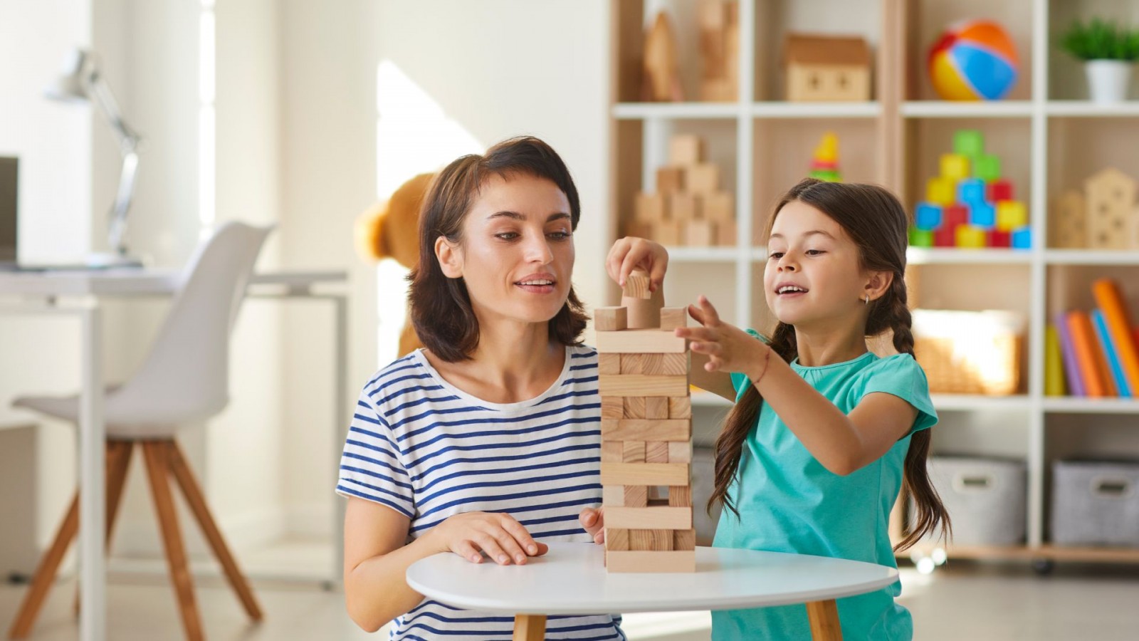 Image of woman and child playing with wooden blocks