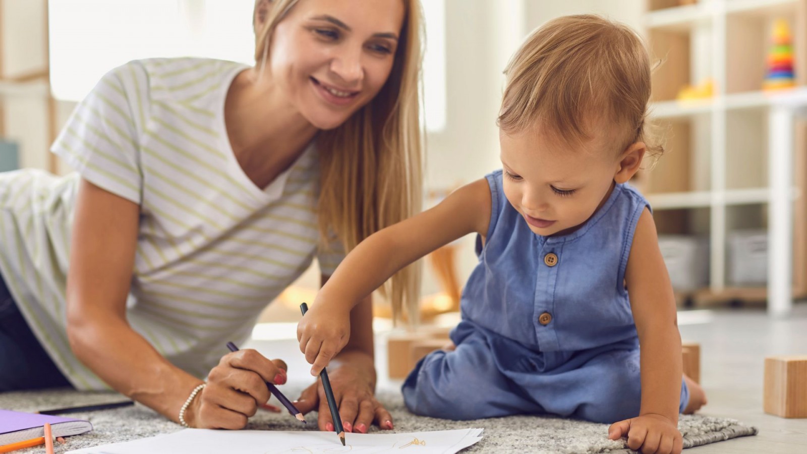 Image of woman drawing with a child