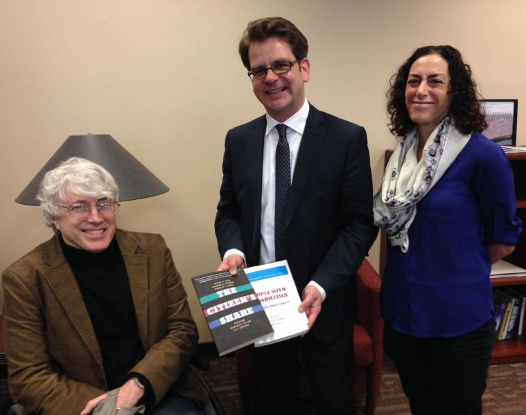 Distinguished Professor Douglas Kruse (left) and Professor Lisa Schur give State Secretary Thorben Albrecht a copy of People with Disabilities: Sidelined or Mainstreamed?, a book they authored with Syracuse University Professor Peter Blanck. Kruse also gave Albrecht a copy of The Citizen’s Share. In that text, Kruse, Distinguished Professor Joseph Blasi, and Richard Freeman, the Herbert Ascherman Chair in Economics at Harvard University, make the case for more companies to offer profit sharing to their employees.